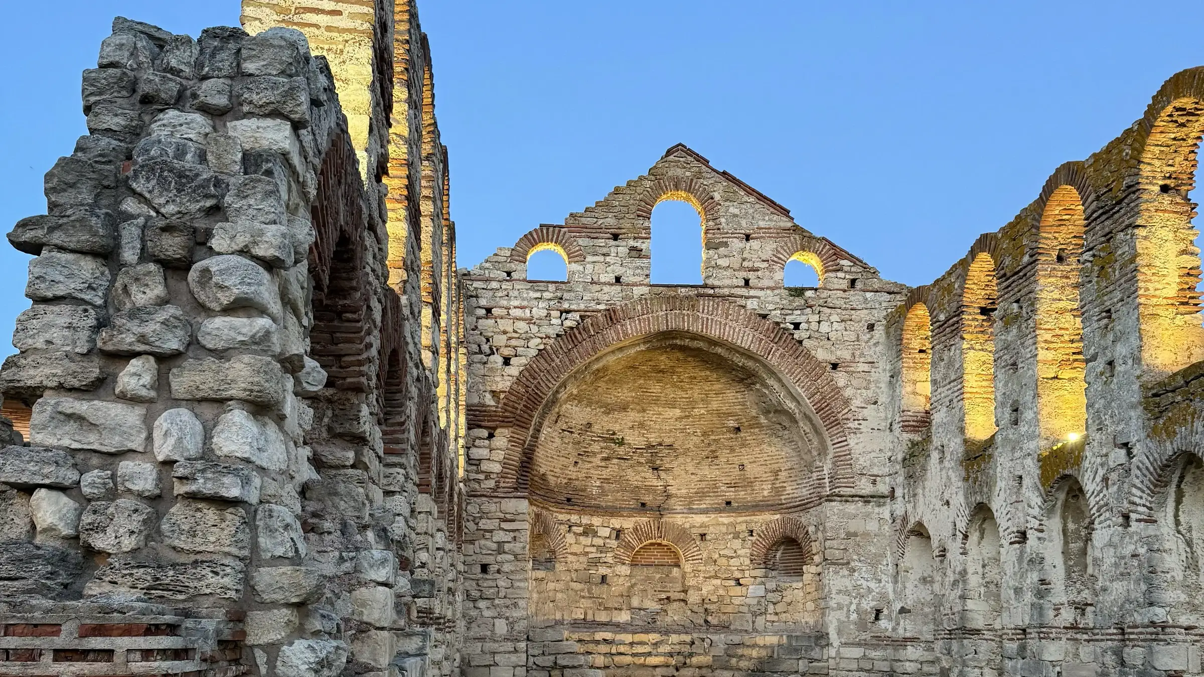 The interior of the Old Metropolitan basilica in Nessebar, its apse and arcades lit at the end of the day